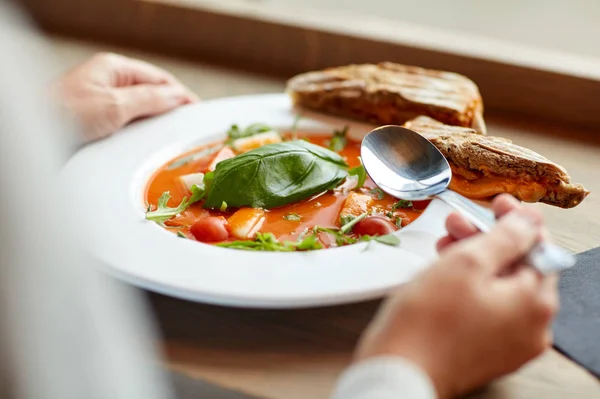 Woman eating gazpacho soup at restaurant — Stock Photo, Image