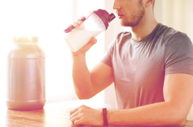 close up of man drinking protein shake clipart