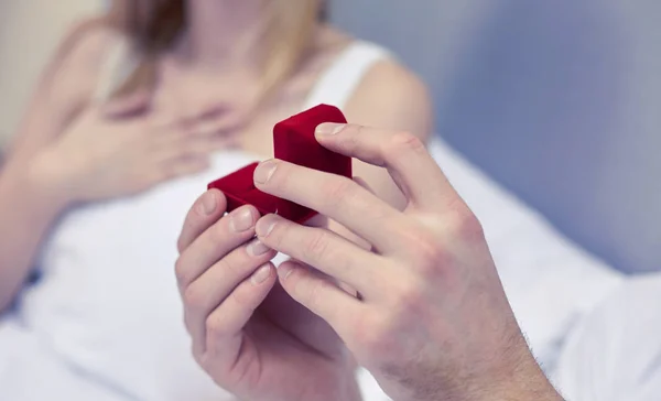 Close up of hands holding little red gift box — Stock Photo, Image