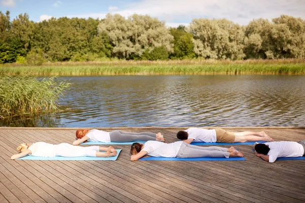 Gruppe von Menschen, die Yoga-Übungen im Freien machen — Stockfoto