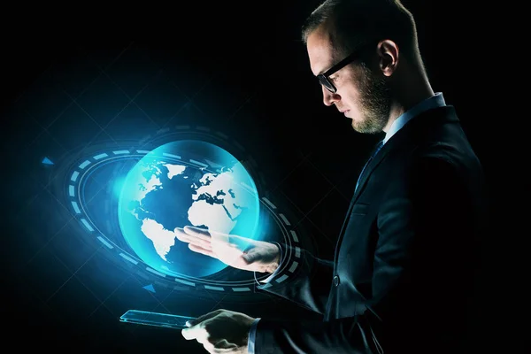 Businessman with tablet pc and earth hologram — Stock Photo, Image