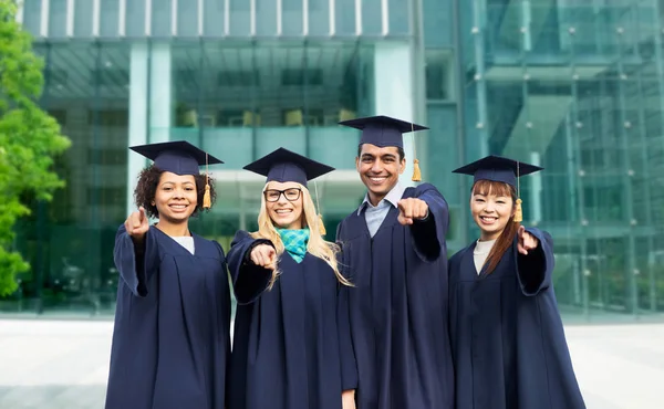 Happy students or bachelors pointing finger at you — Stock Photo, Image