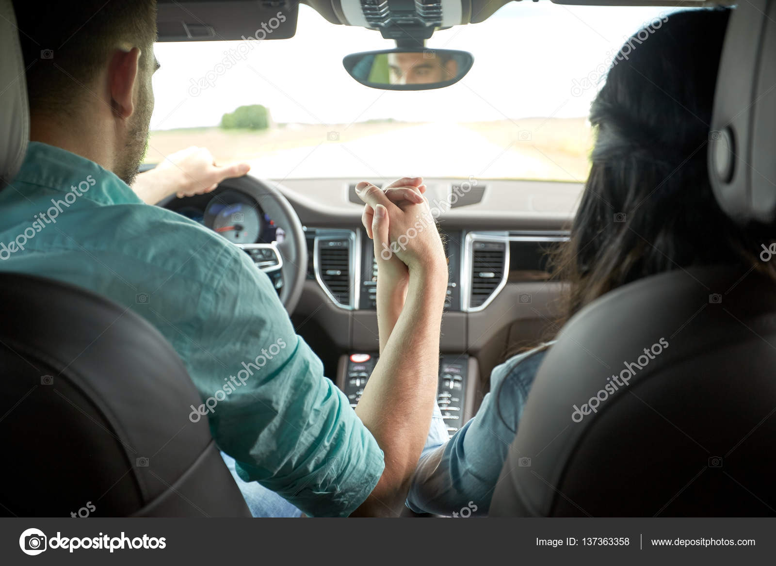 Happy couple driving in car and holding hands — Stock Photo © Syda