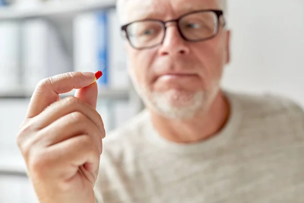 Close up of old man hand with pill — Stock Photo, Image