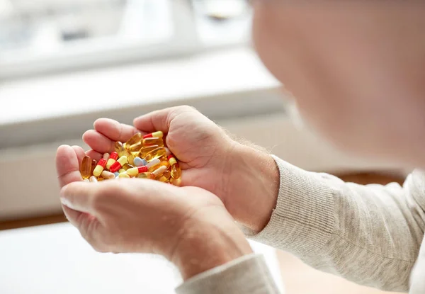 Close up of old man hands holding medicine — Stock Photo, Image