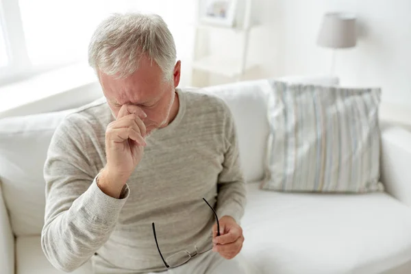 Senior man suffering from headache at home — Stock Photo, Image