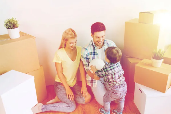 Happy family moving to new home and playing ball — Stock Photo, Image