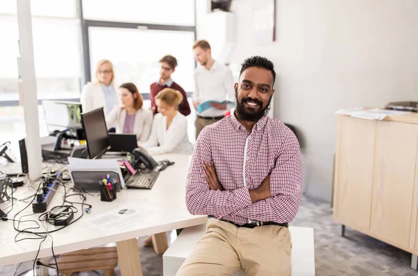 Happy indian man over creative team in office — Stock Photo, Image