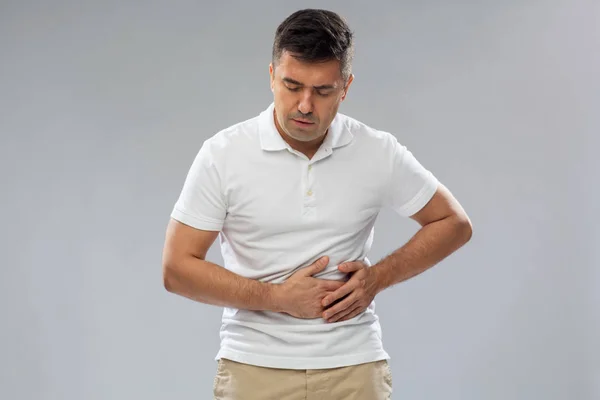Hombre infeliz que sufre de dolor de estómago —  Fotos de Stock