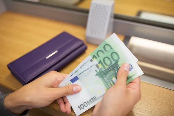 Hands with money at bank or currency exchanger — Stock Photo, Image