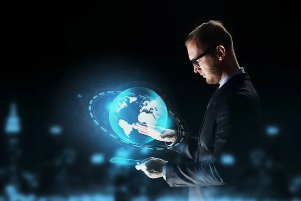 Businessman with tablet pc and earth hologram — Stock Photo, Image