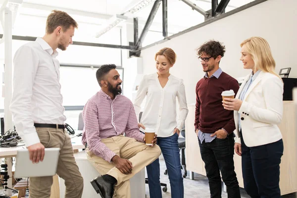 Happy business team drinking coffee at office — Stock Photo, Image