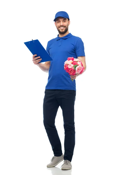 Happy delivery man with flowers and clipboard — Stock Photo, Image