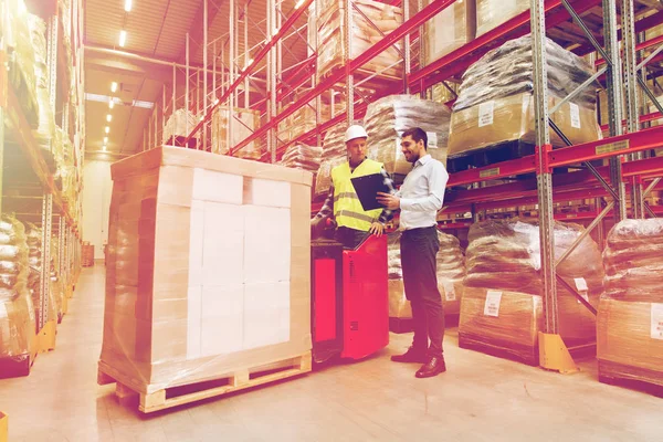 Worker on forklift and businessman at warehouse — Stock Photo, Image