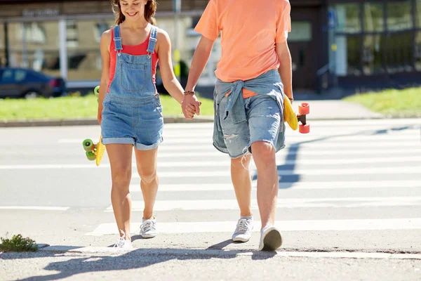 Dospívající pár s skateboardy v městě přechod pro chodce — Stock fotografie
