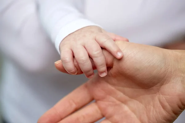 close up of mother and newborn baby hands
