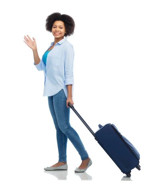 Happy woman with travel bag waving hand — Stock Photo, Image