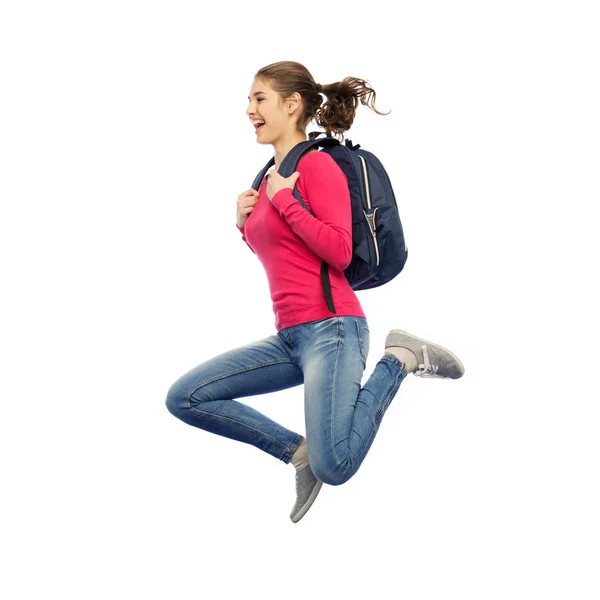 Donna felice o studente con zaino saltando — Foto Stock