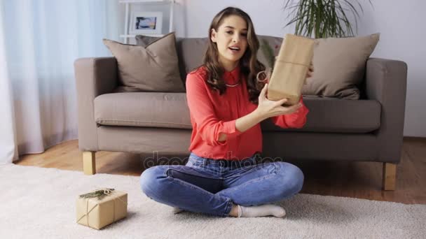 Woman with christmas gifts recording video at home — Stock Video