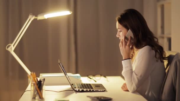 Mujer con portátil llamando en el teléfono inteligente en la oficina — Vídeo de stock