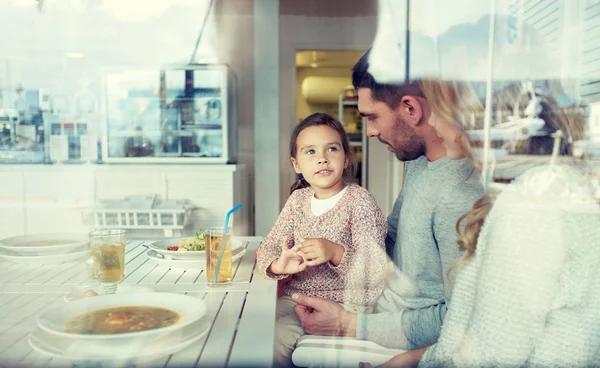 Familia feliz cenando en el restaurante o cafetería — Foto de Stock