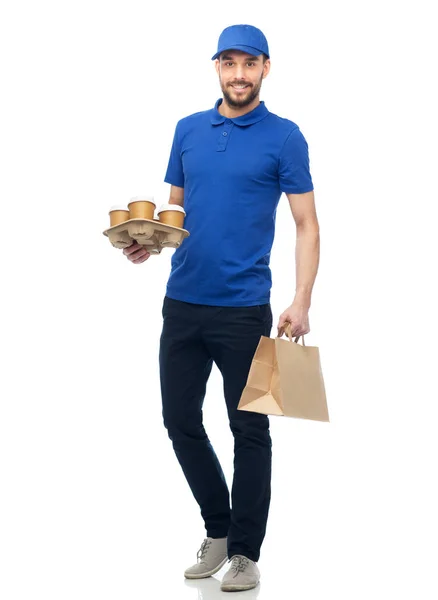 Happy delivery man with coffee and food in bag — Stock Photo, Image