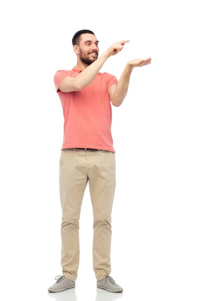 Happy man holding something imaginary on hand — Stock Photo, Image