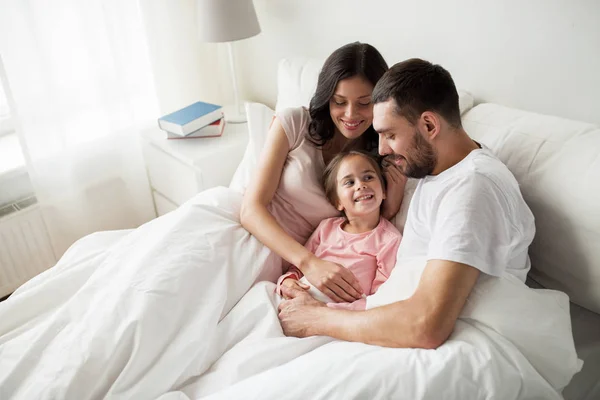 Família feliz na cama em casa — Fotografia de Stock