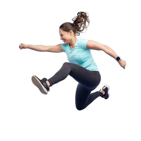 Happy smiling sporty young woman jumping in air — Stock Photo, Image