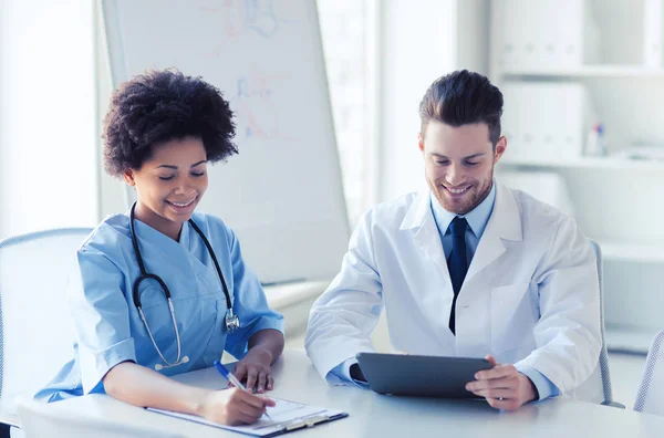 Two happy doctors meeting at hospital office — Stock Photo, Image