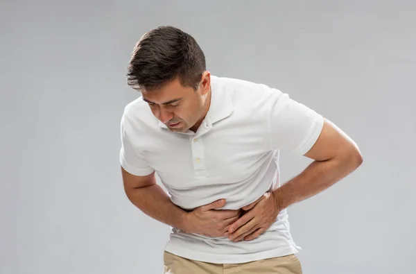 Hombre infeliz que sufre de dolor de estómago — Foto de Stock