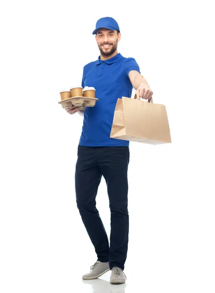 Happy delivery man with coffee and food in bag — Stock Photo, Image