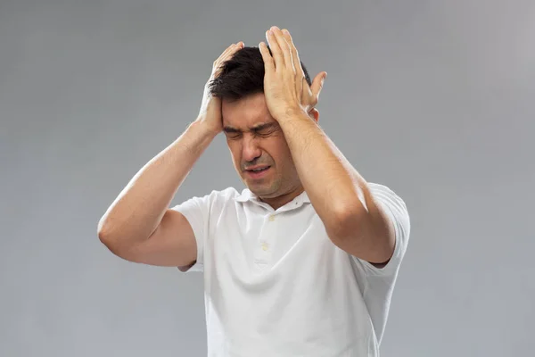 Unhappy man suffering from head ache — Stock Photo, Image