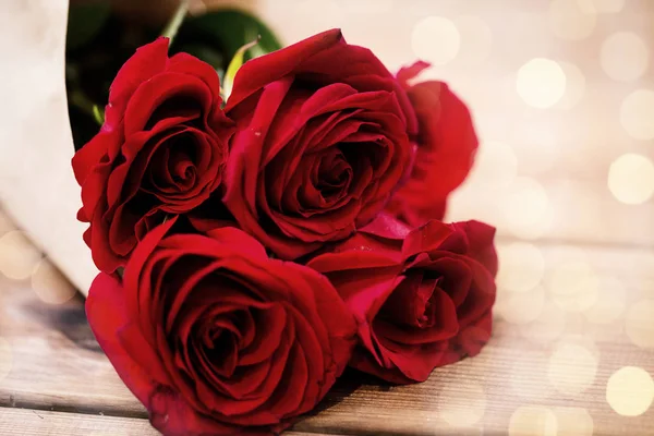 Close up of red roses bunch wrapped into paper — Stock Photo, Image