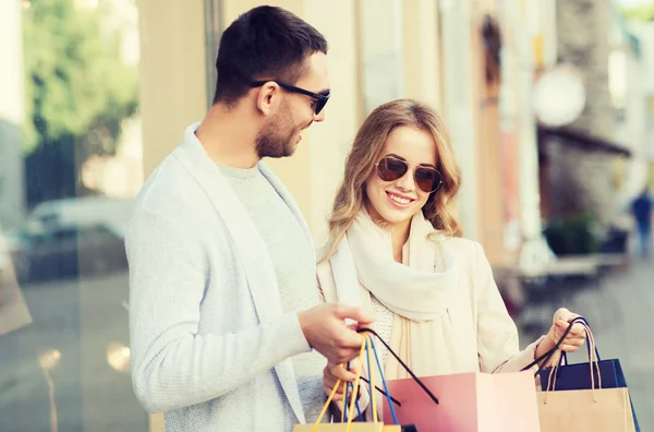 Casal feliz com sacos de compras na rua da cidade — Fotografia de Stock