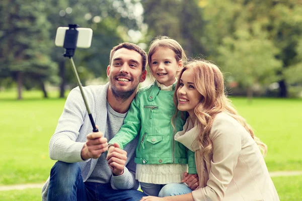 Happy family taking selfie by smartphone outdoors — Stock Photo, Image