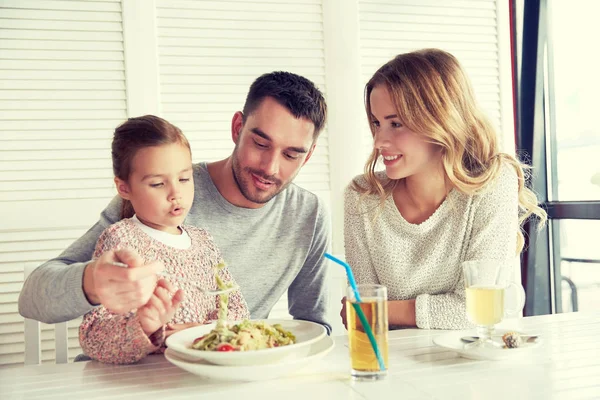 Glückliche Familie beim Abendessen im Restaurant oder Café — Stockfoto