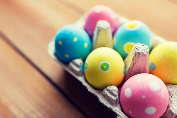 Close up of colored easter eggs in egg box — Stock Photo, Image