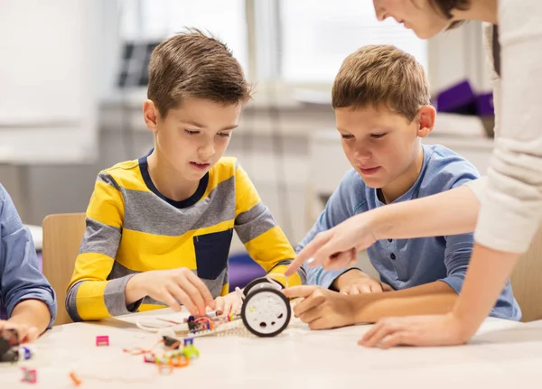 Счастливые дети строят роботов в школе робототехники Стоковая Картинка