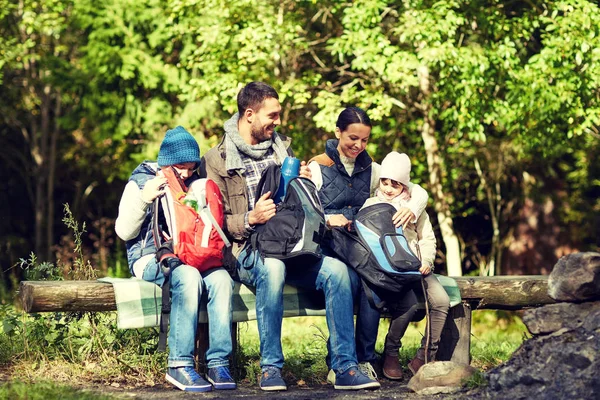 Happy family with backpacks and thermos at camp — Stock Photo, Image