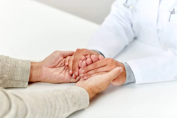 Close up of doctor holding old man hand — Stock Photo, Image