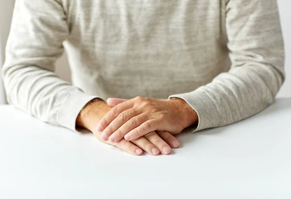 Close up of senior man hands on table — Stock Photo, Image