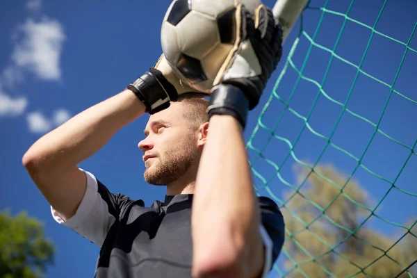 Keeper met bal op voetbal doel op veld — Stockfoto