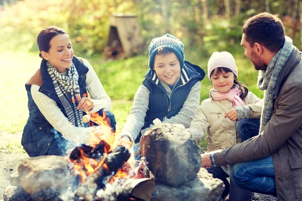 Familia feliz asado malvavisco sobre fogata — Foto de Stock