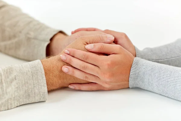 Close up of old man and young woman holding hands — Stock Photo, Image