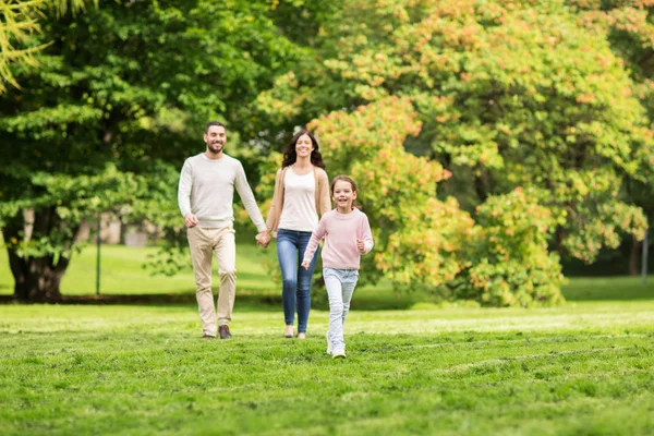 Happy family walking in summer park and having fun — Stock Photo, Image