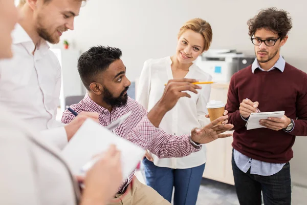 Happy business team discussing something at office — Stock Photo, Image