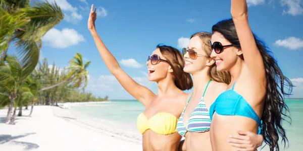 Glückliche junge Frauen im Bikini am Sommerstrand — Stockfoto