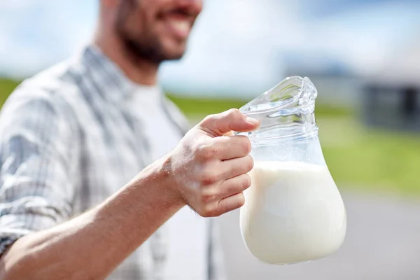 Man or farmer with jug of milk at countryside — Stock Photo, Image