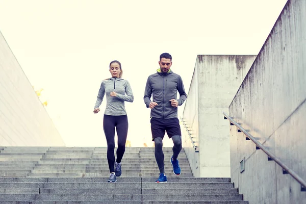 Couple walking downstairs on stadium — Stock Photo, Image